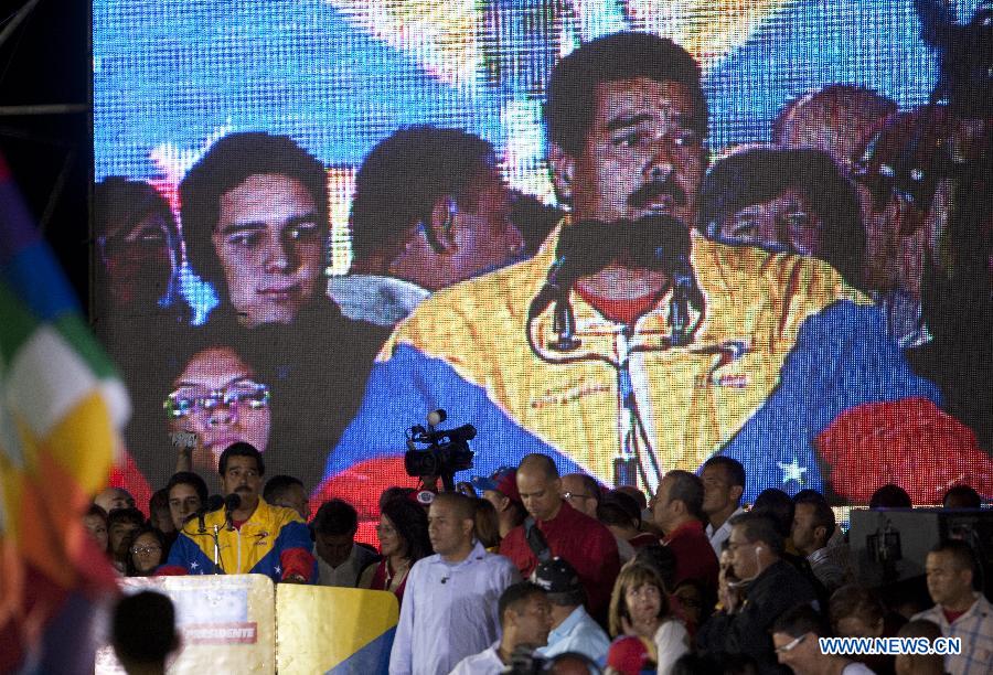 Venezuelan acting President Nicolas Maduro celebrates his victory in Caracas, capital of Venezuela, on April 14, 2013. Venezuelan Acting President Nicolas Maduro narrowly won the presidential election with 50.66 percent of the votes, National Electoral Council's President Tibisay Lucena said on Sunday. (Xinhua/David de la Paz)