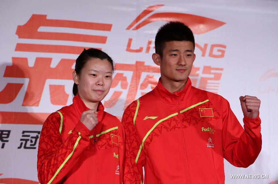Olympic badminton gold medalist and world No. 1 Li Xuerui (L) and badminton world champion Chen Long of China attend a brand promotion event in Taipei, southeast China's Taiwan, April 15, 2013, ahead of the Badminton Asia Championships which will be held in Taipei arena from April 16 to 21. (Xinhua/Xie Xiudong)