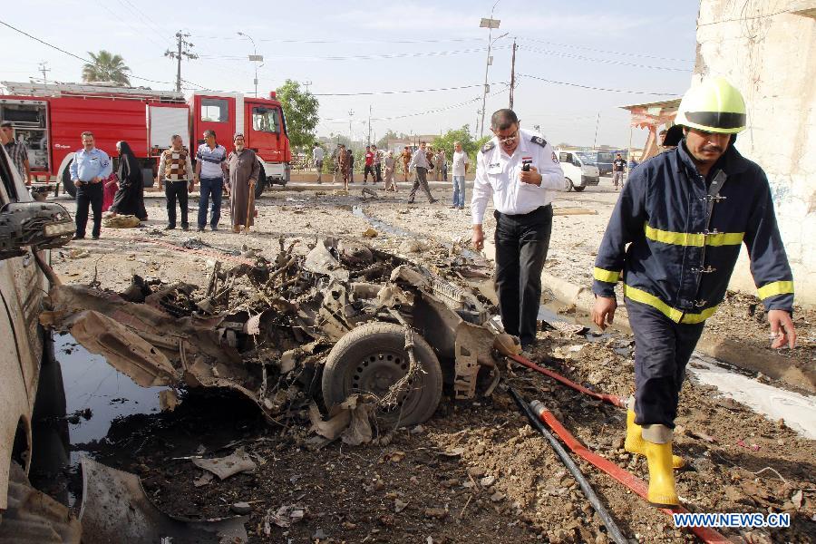 Rescuers look over the site where a car bomb attack happened in Kirkuk, a northern city of Iraq, April 15, 2013. At least 16 people died and 100 people injured in several bomb attacks that happend in different places of Iraq on Monday. (Xinhua/Dena Assad) 