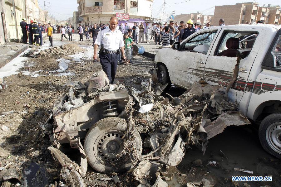 Rescuers look over the site where a car bomb attack happened in Kirkuk, a northern city of Iraq, April 15, 2013. At least 16 people died and 100 people injured in several bomb attacks that happend in different places of Iraq on Monday. (Xinhua/Dena Assad) 