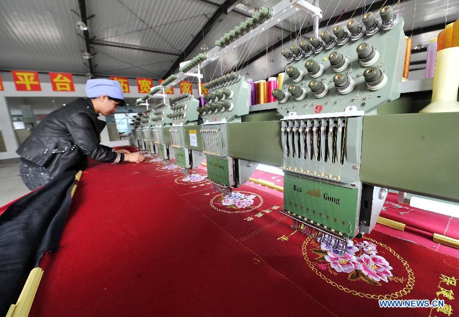 Photo taken on March 13, 2013 shows the workshop of an embroidery factory in Xiji County of northwest China's Ningxia Hui Autonomous Region. China's gross domestic product (GDP) growth unexpectedly slowed to 7.7 percent in the first quarter of 2013, down from 7.9 percent during the final quarter of 2012, data from the National Bureau of Statistics (NBS) showed on April 15, 2013. (Xinhua/Peng Zhaozhi) 