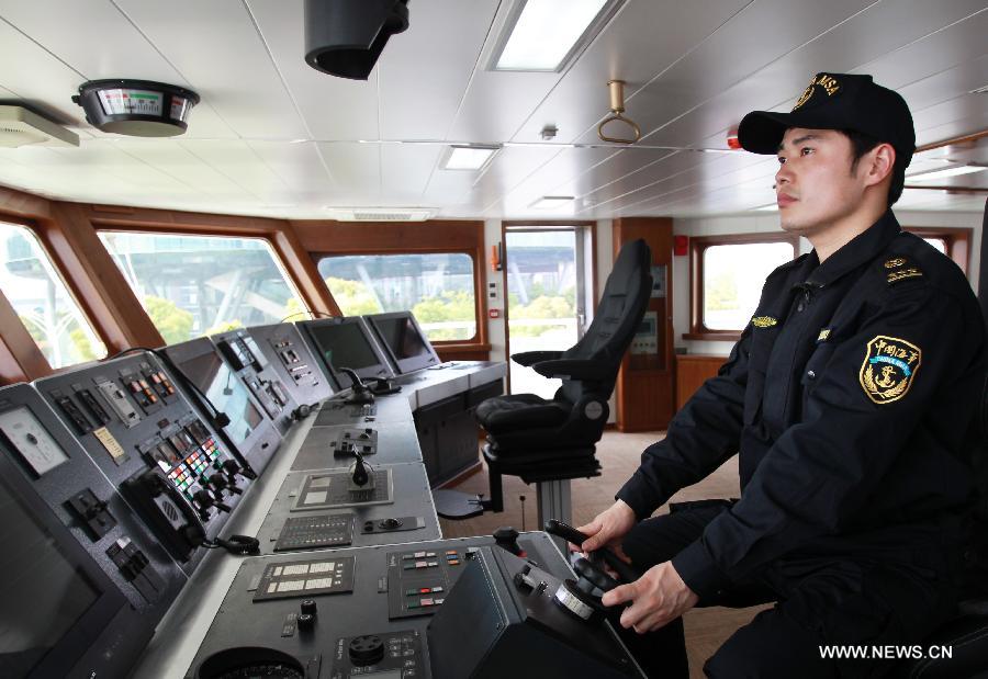A staff member operates patrol vessel Haixun01 for a test in Shanghai, east China, April 15, 2013. Haixun 01, soon to be put into service and managed by the Shanghai Maritime Bureau, is China's largest and most advanced patrol vessel. The 5,418-tonnage Haixun01 is 128.6 meters in length and has a maximum sailing distance of 10,000 nautical miles (18,520 km) without refueling. It will carry out missions regarding maritime inspection, safety monitoring, rescue and oil spill detection and handling. (Xinhua/Chen Fei) 