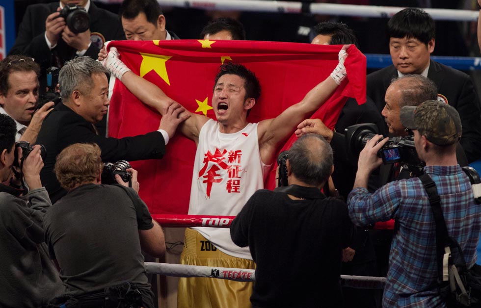 Zou Shiming, 31, the first Chinese boxer to turn professional makes his victory debut in Macao on April 6, 2013. The double Olympic light flyweight champion and three-time World Amateur Champion for his weightclass, defeated Eleazar Valenzuela from Mexico. (Photo by Zhang Jinjia/Xinhua)