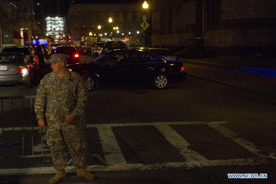 A National Guardsman stands guard in front of the scene of the explosion in Boston, the United States, April 15, 2013. The two explosions that rocked the Boston Marathon on Monday has killed three people and injured at least 138, officials and media outlets said. (Xinhua/Marcus DiPaola)