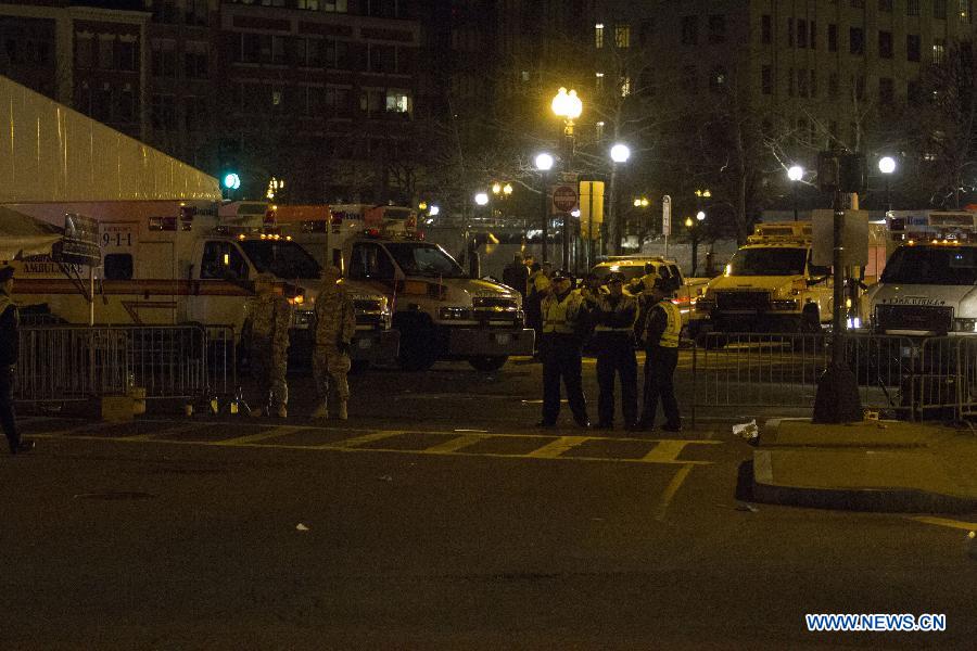 National guardsmen and police stand guard in front of the scene of the explosion in Boston, the United States, April 15, 2013. The two explosions that rocked the Boston Marathon on Monday has killed three people and injured at least 138, officials and media outlets said. (Xinhua/Marcus DiPaola)