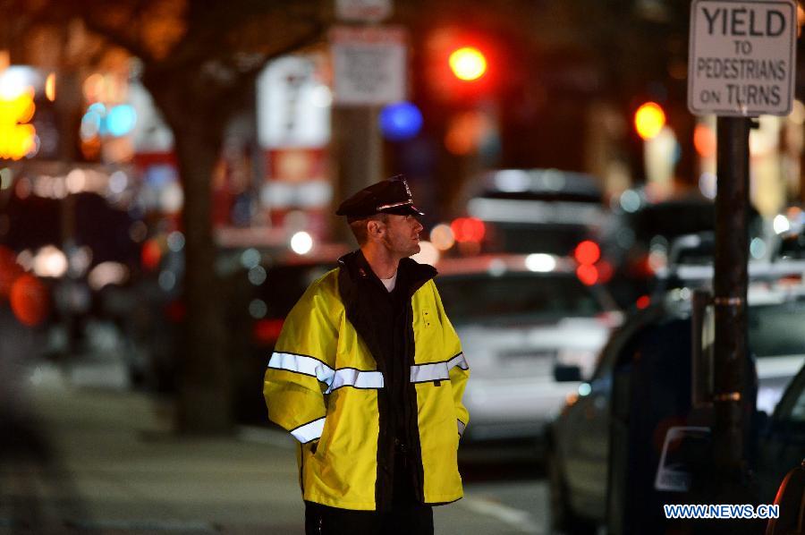 A policeman is on duty near the place where explosions happened in Boston, the United States, April 15, 2013. Three people were killed and 144 people wounded in the explosions according to the statistics published on April 16. (Xinhua/Wang Lei) 