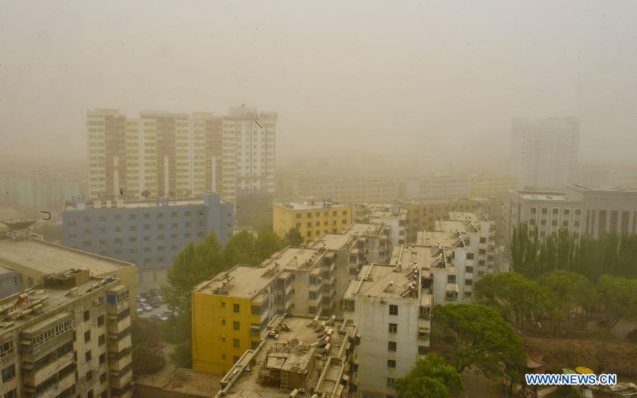 Buildings are pictured amid floating dust in Kashgar, northwest China's Xinjiang Uygur Autonomous Region, April 16, 2013. Gales with dust began to hit Kashgar on Tuesday and will last for four days, according to meteorological authority forecast. (Xinhua/Zhao Ge) 