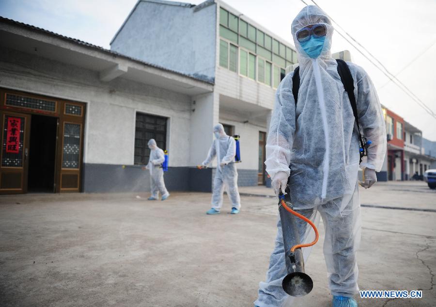 A staff member wearing a protection suit spray disinfectant in front of the house whose proprietor surnamed Chen in Chajian Town of Tianchang City, east China's Anhui Province, April 16, 2013. Chen was tested positive for H7N9 virus on April 15, according to the provincial health department in Anhui. Chen's residence and areas nearby were disinfected thoroughly on April 16. (Xinhua/Du Yu)