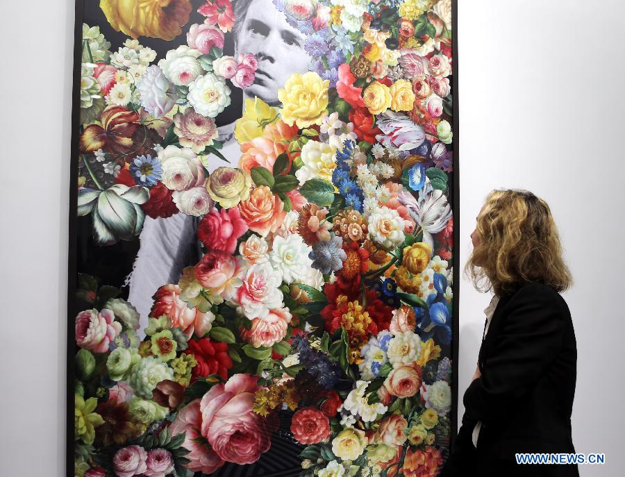 A visitor views a piece of work at the "Flowers of Romance" Installation Art Exhibition by British visual artist Jim Lambie in Hong Kong, south China, April 16, 2013. (Xinhua/Li Peng) 