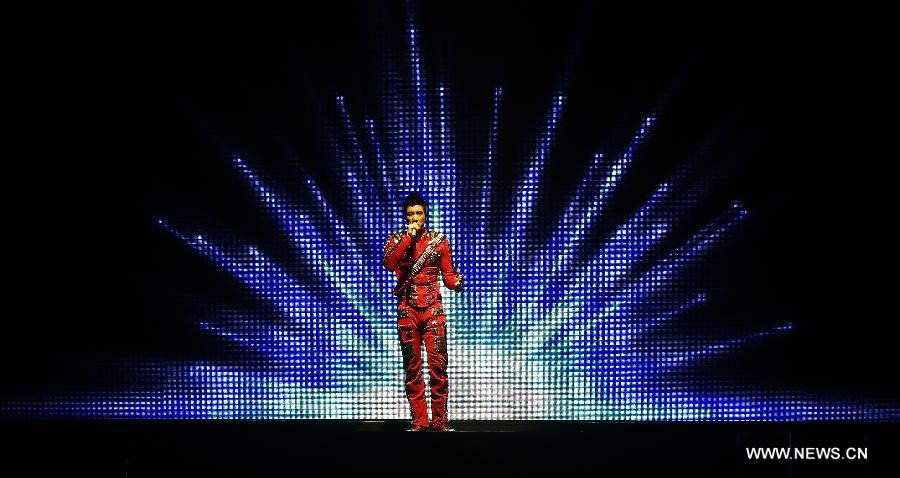 Chinese-American singer-songwriter Leehom Wang performs during Leehom Wang Music Man II-Open Fire at O2 Arena in London, Britain, April 15, 2013. (Xinhua/Wang Lili)  