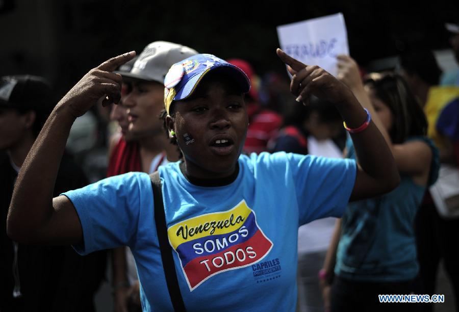Supporters of opposition leader Henrique Capriles participate in a protest in Caracas, capital of Venezuela, on April 16, 2013. Venezuela's elected President Nicolas Maduro said that he would not allow the opposition to go ahead with a planned protest march on Wednesday through the streets of Caracas. (Xinhua/Mauricio Valenzuela) 