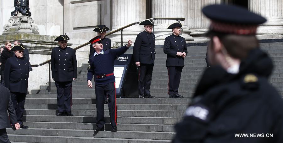 People to attend the funeral of former Prime Minister Margaret Thatcher rehearse outside St Paul's Cathedral in London, April 16, 2013. A ceremonial funeral service for Lady Thatcher will be held at St Paul's Cathedral in London on Wednesday. (Xinhua/Wang Lili) 