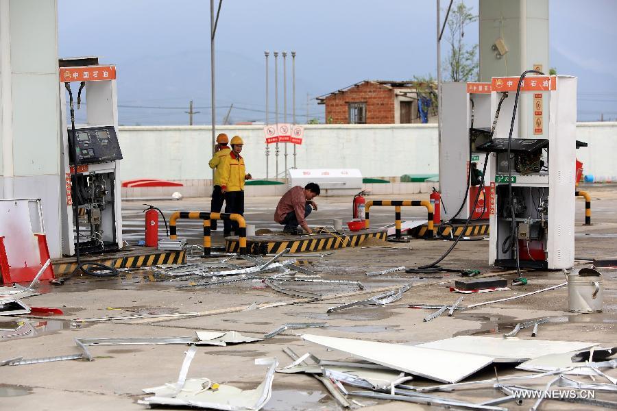 A damaged gas station is pictured after a tornado in Rongan County, south China's Guangxi Zhuang Autonomous Region, April 17, 2013. At least six people were injured and dozens of houses destroyed when a tornado swept through parts of Guangxi on Wednesday morning. The storm hit Qixing District, Guilin City and Rongan County, Liuzhou City at around 5 a.m., local meteorological authorities said. Relief work is under way in the affected areas. (Xinhua/Tan Kaixing) 