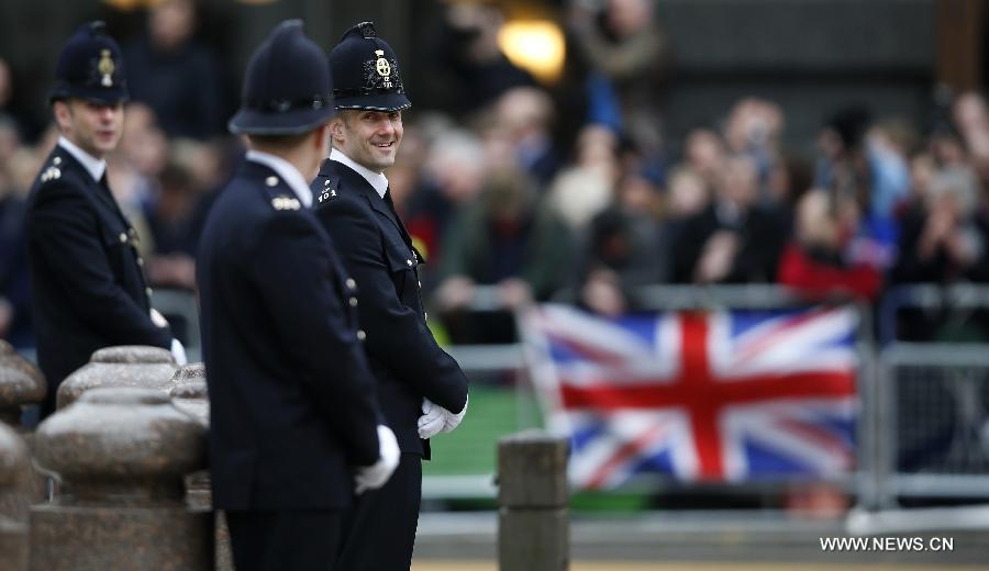 Police officers are on duty for the funeral of former British Prime Minister Margaret Thatcher, outside St. Paul's Cathedral in London, Britain, on April 17, 2013. The funeral of Margaret Thatcher, the first female British prime minister, started 11 a.m. local time on Wednesday in London. (Xinhua/Wang Lili)