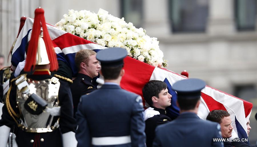 The coffin of British former prime minister Margaret Thatcher is carried out of St. Paul's Cathedral following the ceremonial funeral service in London, Britain, April 17, 2013. The funeral of Margaret Thatcher, the first female British prime minister, started 11 a.m. local time on Wednesday in London. (Xinhua/Wang Lili)