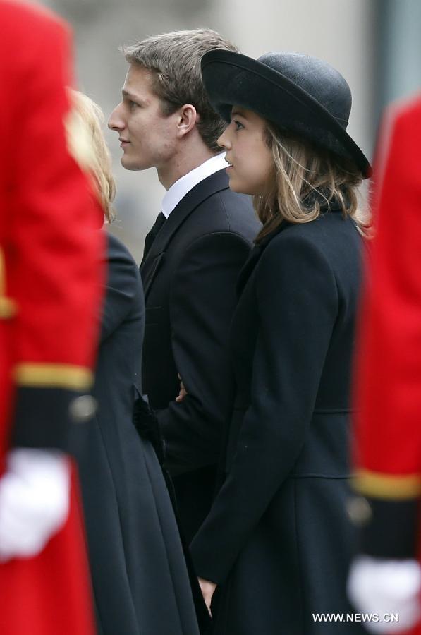 Michael (L) and Amanda Thatcher, grandchildren of former British Prime Minister Margaret Thatcher, arrive for the funeral of former Baroness Thatcher, outside St. Paul's Cathedral in London, Britain, April 17, 2013. The funeral of Margaret Thatcher, the first female British prime minister, started 11 a.m. local time on Wednesday in London. (Xinhua/Wang Lili)