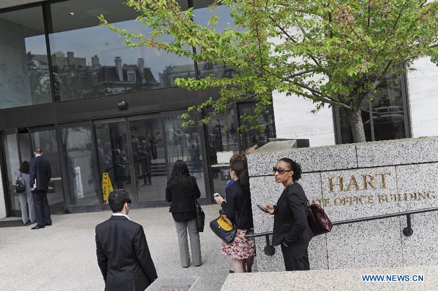 Evacuated people wait outside the Hart Senate office building on Capitol Hill in Washington D.C., capital of the United States, April 17, 2013. U.S. Capitol Police on Wednesday evacuated the Hart and Russell Senate office buildings due to a suspicious envelop. (Xinhua/Zhang Jun) 