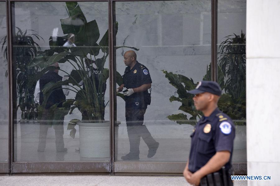 A U.S. Capitol Police officer guards an entrance to the Hart Senate office building on Capitol Hill in Washington D.C., capital of the United States, April 17, 2013. U.S. Capitol Police on Wednesday evacuated the Hart and Russell Senate office buildings due to a suspicious envelop. (Xinhua/Zhang Jun) 