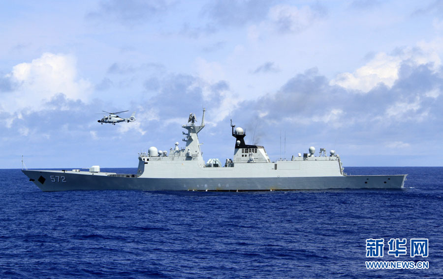 A ship-borne helicopter on the "Lanzhou" warship is checking and identifying over the "Hengshui" warship which simulates a merchant ship. (Xinhua/Yang Lei)