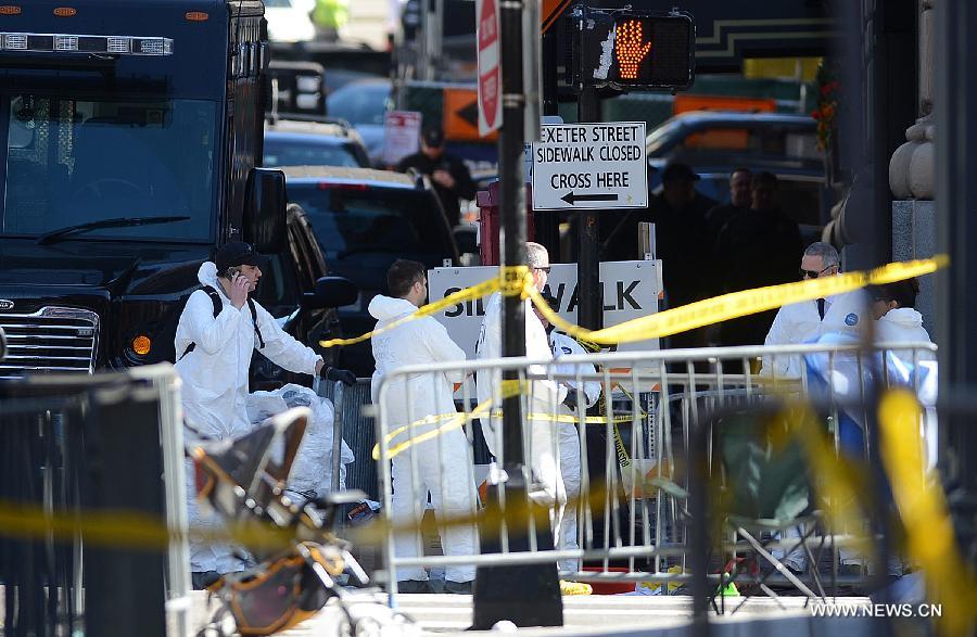 FBI personnel work at the blast site in Boston, the United States, April 17, 2013. U.S. investigators believed that they have identified a suspect for Monday's Boston Marathon bombings, which killed three people and injured over 170 others, U.S. media reported on Wednesday. (Xinhua/Wang Lei) 