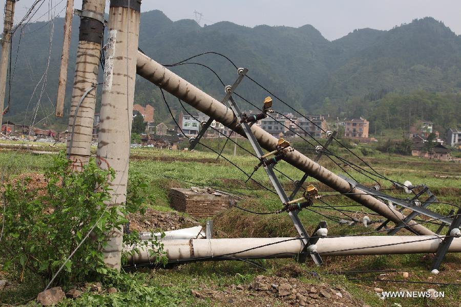 Photo taken on April 18, 2013 shows the fallen telegraph poles after tornado and hailstorm hit Zhenyuan County, southwest China's Guizhou Province. The county was hit by tornado and hailstorm on Wednesday night with houses wrecked and vehicles smashed by fallen trees. (Xinhua)