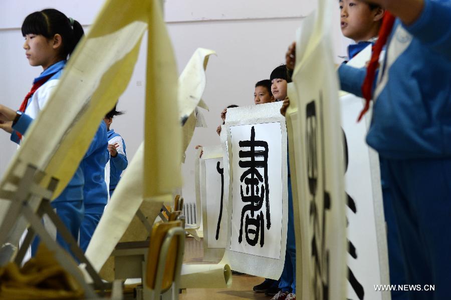 Students attend a calligraphy class at Beijing No. 94 Middle School Airport Campus in Beijing, capital of China, April 18, 2013. The Chinese Ministry of Education has published a guideline on calligraphy education for the country's primary and middle schools in February, setting specific calligraphy course requirements for each period of study and calls for including the courses in evaluations of the schools' performance. In China, calligraphy has been revered as an art form since it was first used in the fifth century BC. (Xinhua/Jin Liangkuai) 