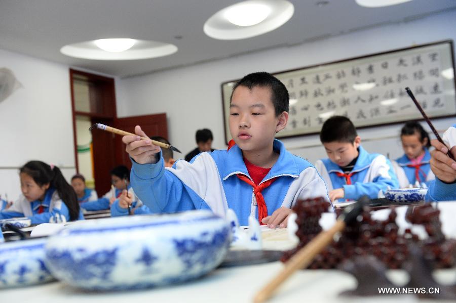 Students attend a calligraphy class at Beijing No. 94 Middle School Airport Campus in Beijing, capital of China, April 18, 2013. The Chinese Ministry of Education has published a guideline on calligraphy education for the country's primary and middle schools in February, setting specific calligraphy course requirements for each period of study and calls for including the courses in evaluations of the schools' performance. In China, calligraphy has been revered as an art form since it was first used in the fifth century BC. (Xinhua/Jin Liangkuai) 