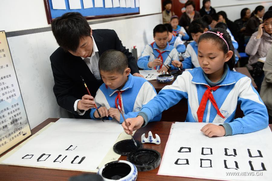 Students attend a calligraphy class at Beijing No. 94 Middle School Airport Campus in Beijing, capital of China, April 18, 2013. The Chinese Ministry of Education has published a guideline on calligraphy education for the country's primary and middle schools in February, setting specific calligraphy course requirements for each period of study and calls for including the courses in evaluations of the schools' performance. In China, calligraphy has been revered as an art form since it was first used in the fifth century BC. (Xinhua/Jin Liangkuai) 