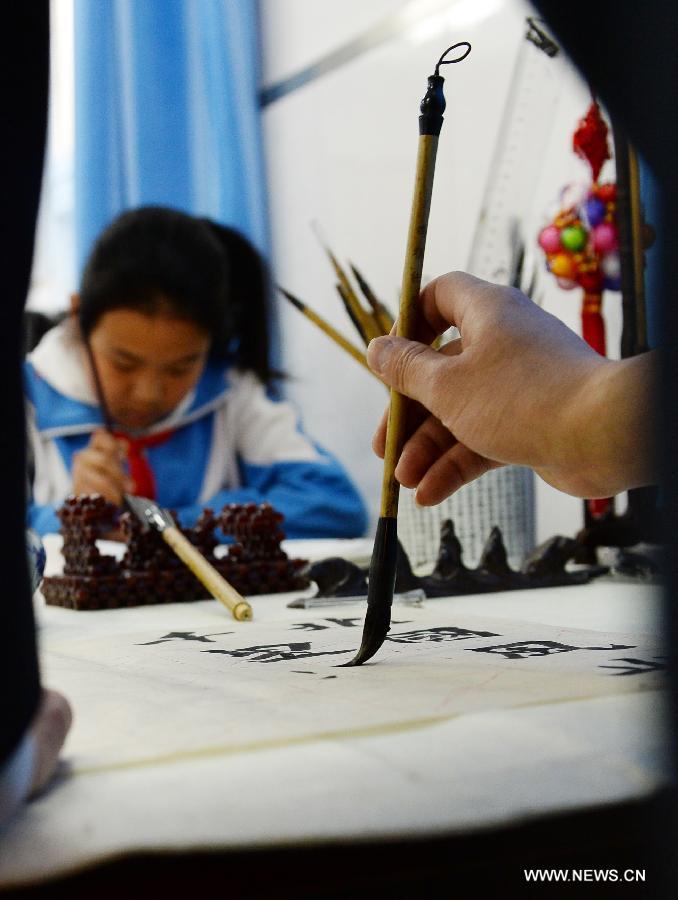 Students attend a calligraphy class at Beijing No. 94 Middle School Airport Campus in Beijing, capital of China, April 18, 2013. The Chinese Ministry of Education has published a guideline on calligraphy education for the country's primary and middle schools in February, setting specific calligraphy course requirements for each period of study and calls for including the courses in evaluations of the schools' performance. In China, calligraphy has been revered as an art form since it was first used in the fifth century BC. (Xinhua/Jin Liangkuai) 