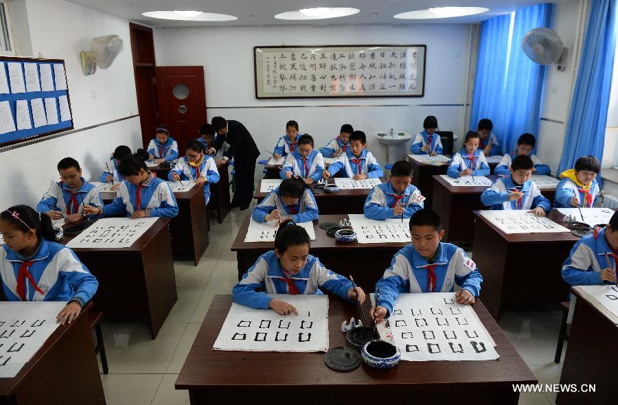 Students attend a calligraphy class at Beijing No. 94 Middle School Airport Campus in Beijing, capital of China, April 18, 2013. The Chinese Ministry of Education has published a guideline on calligraphy education for the country's primary and middle schools in February, setting specific calligraphy course requirements for each period of study and calls for including the courses in evaluations of the schools' performance. In China, calligraphy has been revered as an art form since it was first used in the fifth century BC. (Xinhua/Jin Liangkuai) 