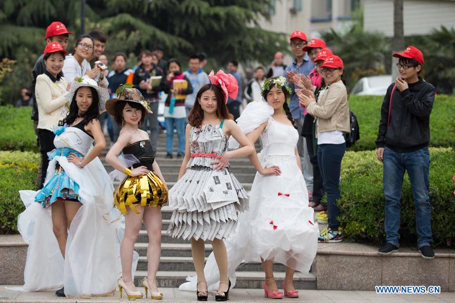 Models present creations made of waste materials during a "low-carbon fashion show" in Huaibei, east China's Anhui Province, April 18, 2013. Students of the Huaibei Normal University and employees of local power supply company were involved on the event held to call for environmental protection. (Xinhua/Wang Wen) 