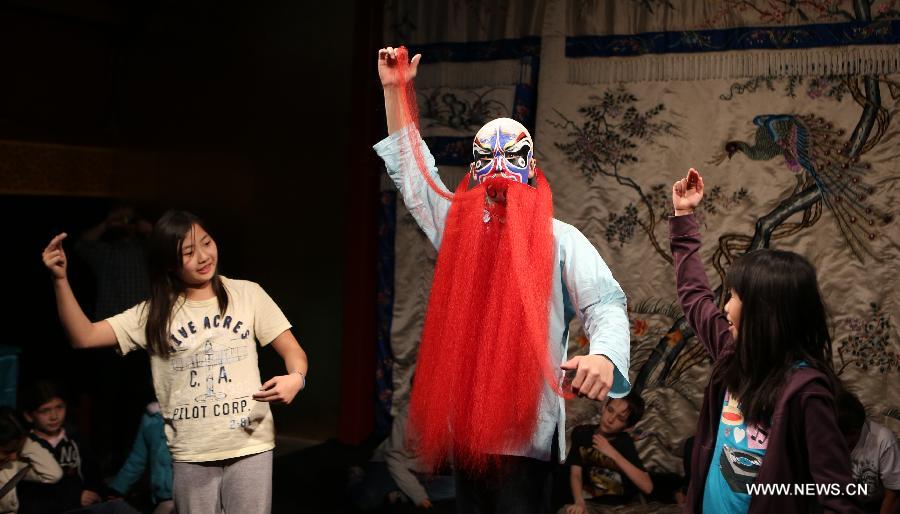 Two girls learn Peking Opera performance at the Temple Theatre Beijing Opera House in Beijing, capital of China, April 18, 2013. Students from an international school in Beijing participated in a public education activity named "the charm of Sheng, Dan, Jing, Chou in Peking Opera" on Thursday here. "Sheng","Dan","Jing" and "Chou" refer to different roles in Peking Opera. (Xinhua/Pan Siwei) 