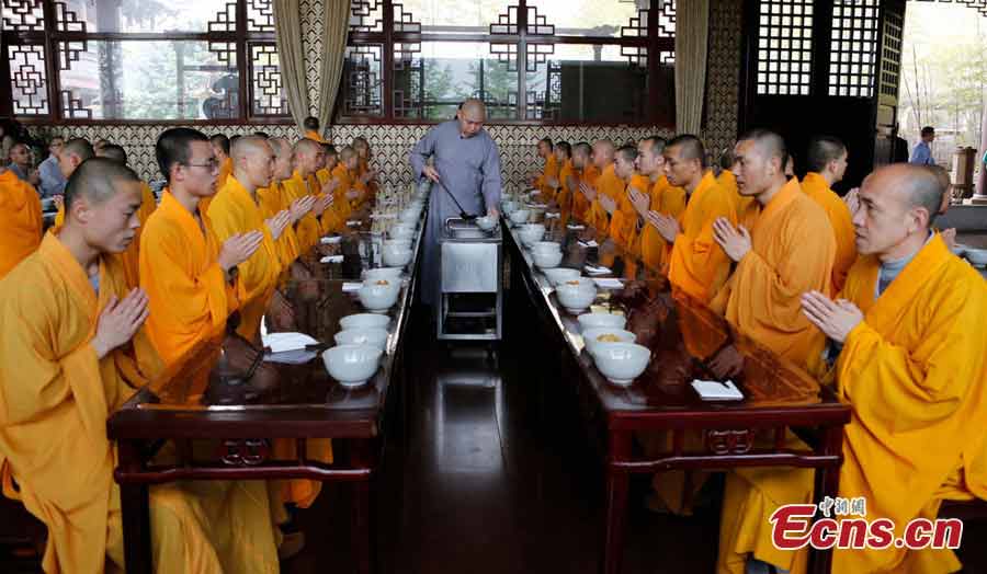 Students have lunch at the Buddhist Academy of Emei Mountain in Emei Mountain, Southwest China's Sichuan Province. Established in 1927, the school, covering an area of more than 10,000 square meters presently, has courses mainly on Buddhism studying. (CNS/Liu Zhongjun)