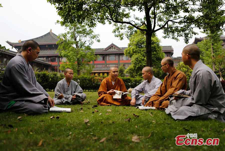Students talk with their teachers at the Buddhist Academy of Emei Mountain in Emei Mountain, Southwest China's Sichuan Province. Established in 1927, the school, covering an area of more than 10,000 square meters presently, has courses mainly on Buddhism studying. (CNS/Liu Zhongjun)