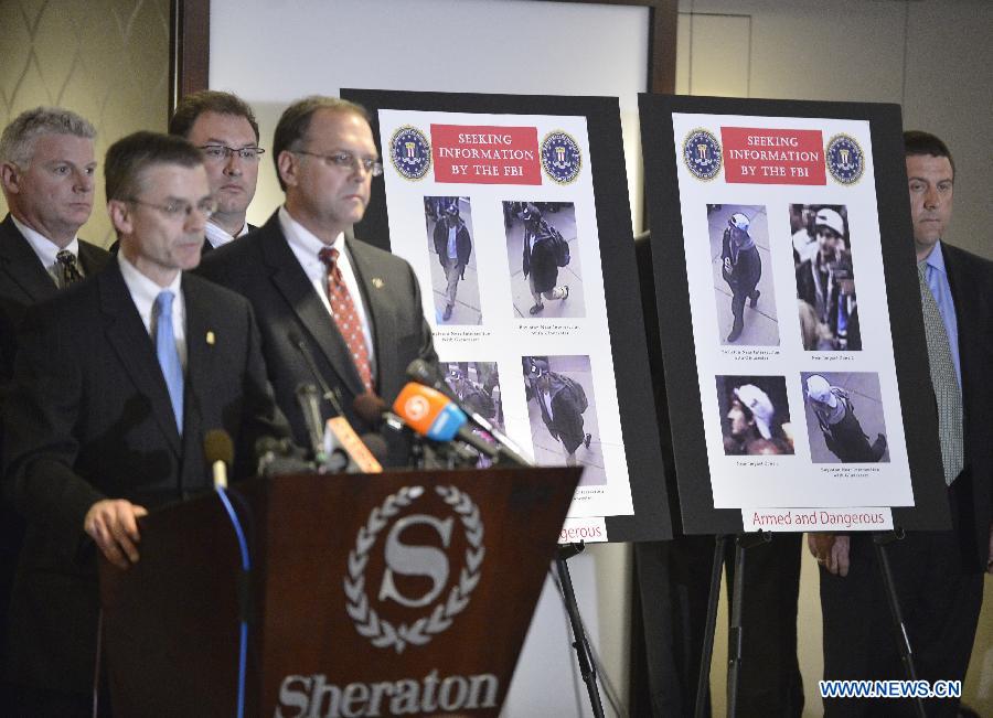 Photos of two suspects for the Boston Marathon bombings are seen during a press conference to release their photos and video in Boston, April 18, 2013. The FBI special agent Richard DesLauriers on Thursday released the photos and video of two suspects for Monday's deadly bombings in Boston, asking for the public's help to identify them. (Xinhua/Zhang Jun)
