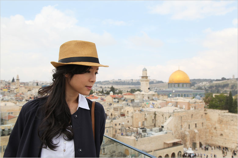 Actress Zhang Jingchu poses for photos during a break from filming the movie "The Old Cinderella" on the roof of Aish Hatorah near the Western Wall in the Old City of Jerusalem on Thursday, April 18, 2013. [Photo: CRIENGLISH.com / Zhang Jin]  