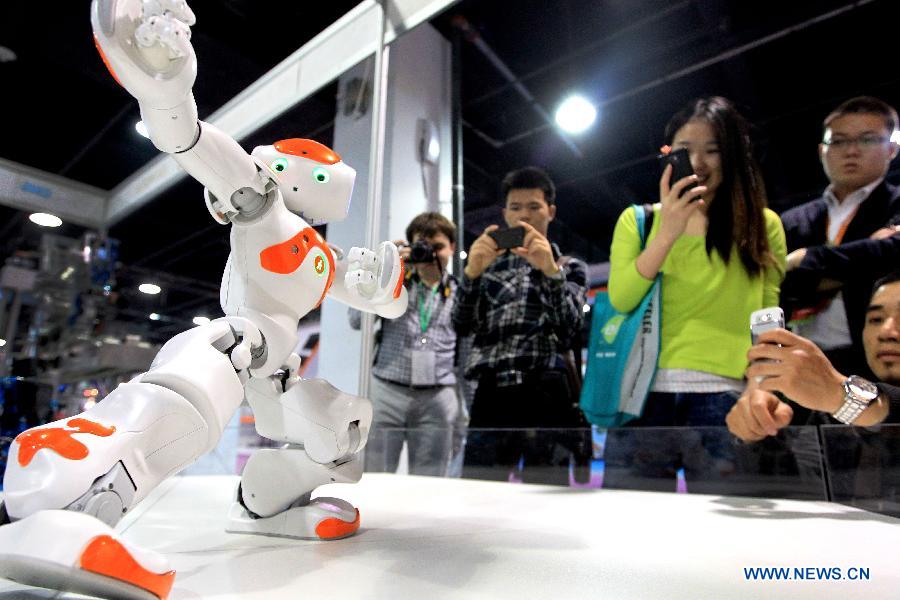 Robot "NAO" plays the traditional Chinese Tachi fist during the 7th China Hangzhou Electronics & Information Fair in Hangzhou, capital of east China's Zhejiang Province, April 18, 2013. The fair, which kicked off on April 18, will last until April 21. (Xinhua/Wu Huang)