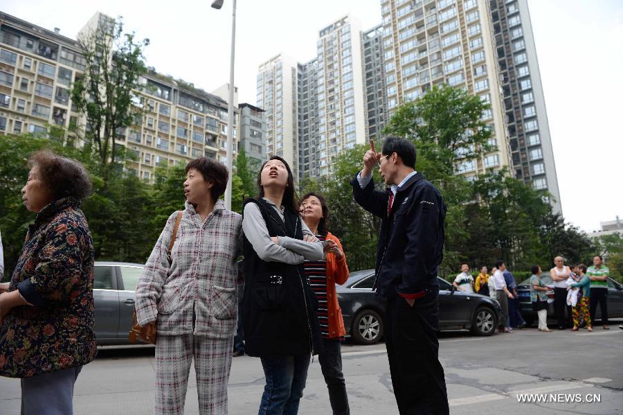 Citizens gather outside their apartments to avoid aftershocks of the earthquake in Chengdu, capital of southwest China's Sichuan Province, April 20, 2013. A 7.0-magnitude earthquake hit Lushan County of Sichuan Province at 8:02 a.m. Beijing Time (0002 GMT) on Saturday, according to the China Earthquake Networks Center (CENC). The epicenter, with a depth of 13 kilometers, was monitored at 30.3 degrees north latitude and 103.0 degrees east longitude. Residents in Chengdu felt the earthquake. (Xinhua/Li Qiaoqiao)