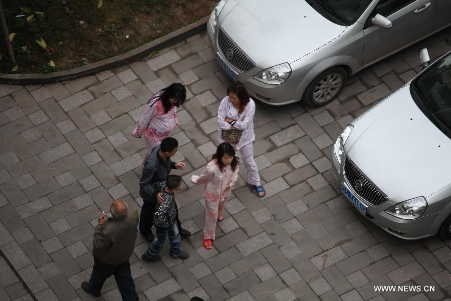 Citizens rush to run from their apartments to avoid aftershocks of an earthquake, in Chongqing, adjacent to southwest China's Sichuan Province, April 20, 2013. A 7.0-magnitude earthquake hit Lushan County of Sichuan Province at 8:02 a.m. Beijing Time (0002 GMT) on Saturday, according to the China Earthquake Networks Center (CENC). The epicenter, with a depth of 13 kilometers, was monitored at 30.3 degrees north latitude and 103.0 degrees east longitude. Residents in Chongqing felt the earthquake. (Xinhua/Luo Guojia)