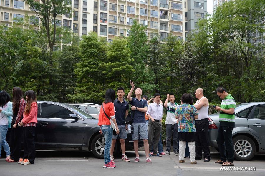 Citizens gather outside their apartments to avoid aftershocks of the earthquake in Chengdu, capital of southwest China's Sichuan Province, April 20, 2013. A 7.0-magnitude earthquake hit Lushan County of Sichuan Province at 8:02 a.m. Beijing Time (0002 GMT) on Saturday, according to the China Earthquake Networks Center (CENC). The epicenter, with a depth of 13 kilometers, was monitored at 30.3 degrees north latitude and 103.0 degrees east longitude. Residents in Chengdu felt the earthquake. (Xinhua/Li Qiaoqiao) 