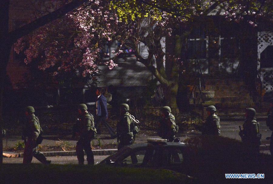 Policemen leave the place where a suspect of the Boston bombings was arrested in the Watertown district of Boston, the United States, April 19, 2013. Suspect of the Boston Marathon bombings, 19-year-old Dzhokhar A. Tsarnaev, was captured on a boat parked on a residential property in Watertown, the state of Massachusetts, on Friday. (Xinhua/Zhang Jun) 