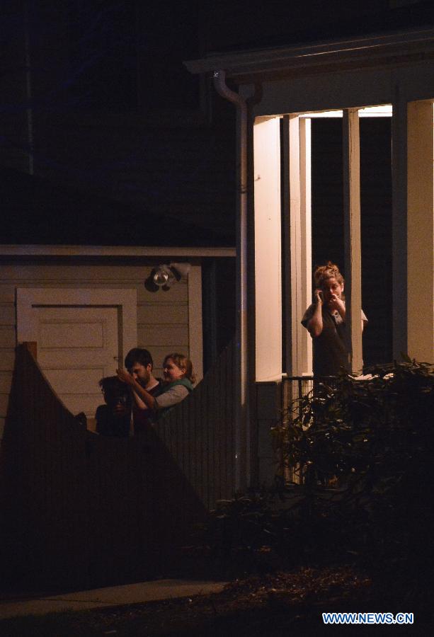 Residents walk out of their houses after a suspect of the Boston bombings was arrested in Watertown of Boston, the United States, April 19, 2013. Suspect of the Boston Marathon bombings, 19-year-old Dzhokhar A. Tsarnaev, was captured on a boat parked on a residential property in Watertown, the state of Massachusetts, on Friday. (Xinhua/Zhang Jun) 