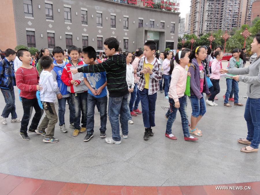 Students are arranged to stay on a palyground to avoid aftershocks of a quake, in Dazhou, southwest China's Sichuan Province, April 20, 2013. A 7.0-magnitude earthquake hit Lushan County of Sichuan Province at 8:02 a.m. Beijing Time (0002 GMT) on Saturday, according to the China Earthquake Networks Center (CENC). The epicenter, with a depth of 13 kilometers, was monitored at 30.3 degrees north latitude and 103.0 degrees east longitude. Multiple aftershocks jolted the area after the 7.0 magnitude quake took place, the largest aftershock in magnitude being the 5.1-magnitude one which shook the bordering area of Lushan and Baoxing counties of Sichuan at 8:07 a.m.(Xinhua/Deng Liangkui) 