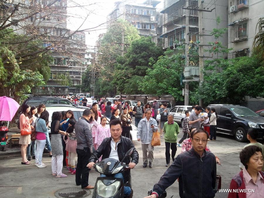 Citizens stay outside their apartments to avoid aftershocks of a quake, in Chengdu, capital of southwest China's Sichuan Province, April 20, 2013. A 7.0-magnitude earthquake hit Lushan County of Sichuan Province at 8:02 a.m. Beijing Time (0002 GMT) on Saturday, according to the China Earthquake Networks Center (CENC). The epicenter, with a depth of 13 kilometers, was monitored at 30.3 degrees north latitude and 103.0 degrees east longitude. Residents in Chengdu felt the earthquake. Multiple aftershocks jolted the area after the 7.0 magnitude quake took place, the largest aftershock in magnitude being the 5.1-magnitude one which shook the bordering area of Lushan and Baoxing counties of Sichuan at 8:07 a.m. (Xinhua/Wei Dezhi)