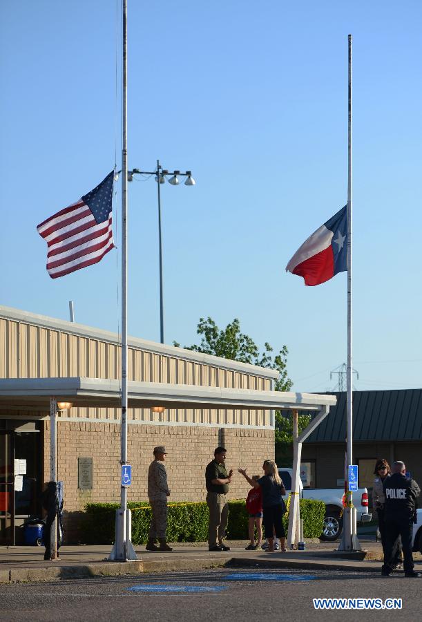 Flags are at half mast at a community center in West, Texas, the United States, April 19, 2013. The massive explosion at a Texas fertilizer plant on Wednesday has killed 14 people and injured more than 160 others, local authorities said Thursday. Texas Governor Rick Perry has declared McLennan County a disaster area, saying he would ask for federal disaster aid from President Barack Obama. (Xinhua/Wang Lei) 