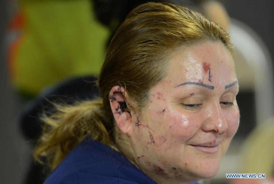 A woman injured in the fertilizer plant blast rests in a church in West, Texas, the United States, April 19, 2013. The massive explosion at a Texas fertilizer plant on Wednesday has killed 14 people and injured more than 160 others, local authorities said Thursday. Texas Governor Rick Perry has declared McLennan County a disaster area, saying he would ask for federal disaster aid from President Barack Obama. (Xinhua/Wang Lei) 