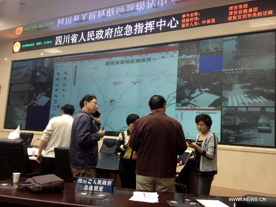 Staff members are busy with working in the Emergency Command Center of the Sichuan Provincial Government in Chengdu, capital of southwest China's Sichuan Province, April 20, 2013. The provincial government held the first press conference at 11:30 a.m. (0300 GMT) in Chengdu after a 7-magnitude earthquake hit Lushan county of Ya'an city in Sichuan Province Saturday morning, according to the China Earthquake Networks Center (CENC). The quake has claimed 56 lives by the time of news release. (Xinhua/Li Hualiang)