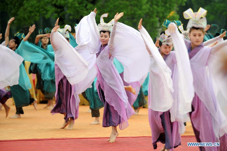 Performers dance during a memorial ceremony in honor of Da Yu, a legendary Chinese hero who tamed the Yellow River and made it beneficial to farming in the prehistorical era, held in Shaoxing City, east China's Zhejiang Province, April 20, 2013. (Xinhua/Ju Huanzong)