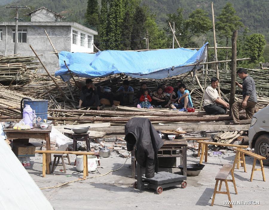 Residents rest in a makeshift tent after a 7.0-magnitude earthquake occurred in Longmen Township, Lushan County, Ya'an City of southwest China's Sichuan Province, April 20, 2013. At least 113 people have been killed in the earthquake in Sichuan as of 4:40 p.m. on Saturday, according to the provincial seismological bureau. (Xinhua) 