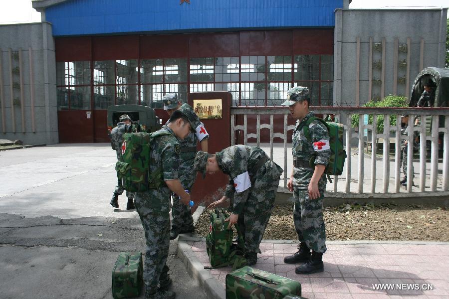 Military surgeons prepare to board on a helicopter flying for the quake-hit areas of southwest China's Sichuan Province, April 20, 2013. A 7.0-magnitude earthquake earthquake hit Lushan county of Ya'an City in Sichuan at 8:02 a.m. Saturday Beijing Time. At least 113 people were confirmed dead by far. (Xinhua/Xia Rui) 